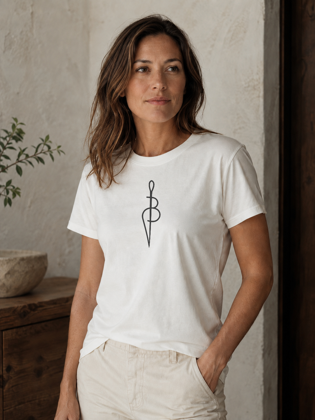 Woman wearing a white Proof of Wear Signature Stitch T-shirt